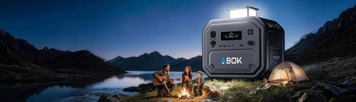 ABOK Ark2500 portable power station with its LED light raised beside a family campsite at night.
